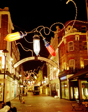 Christmas lights at night over an empty Carnaby Street in Londonwith a delivery truck in the background